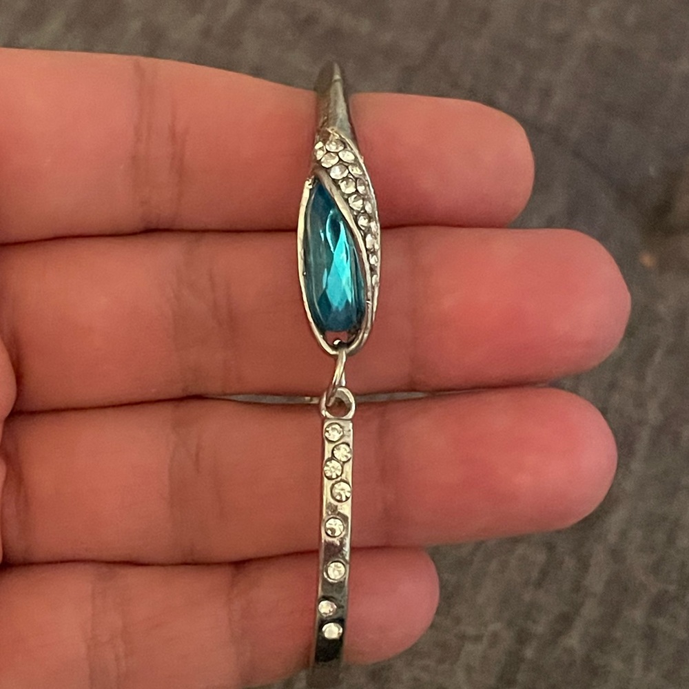 Silver tone and blue stone bracelet. Unique design.